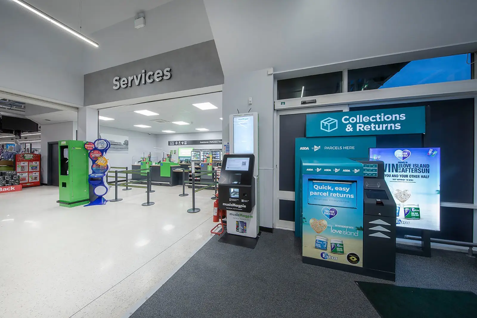 A store's service area with a collections and returns kiosk and several green machines.