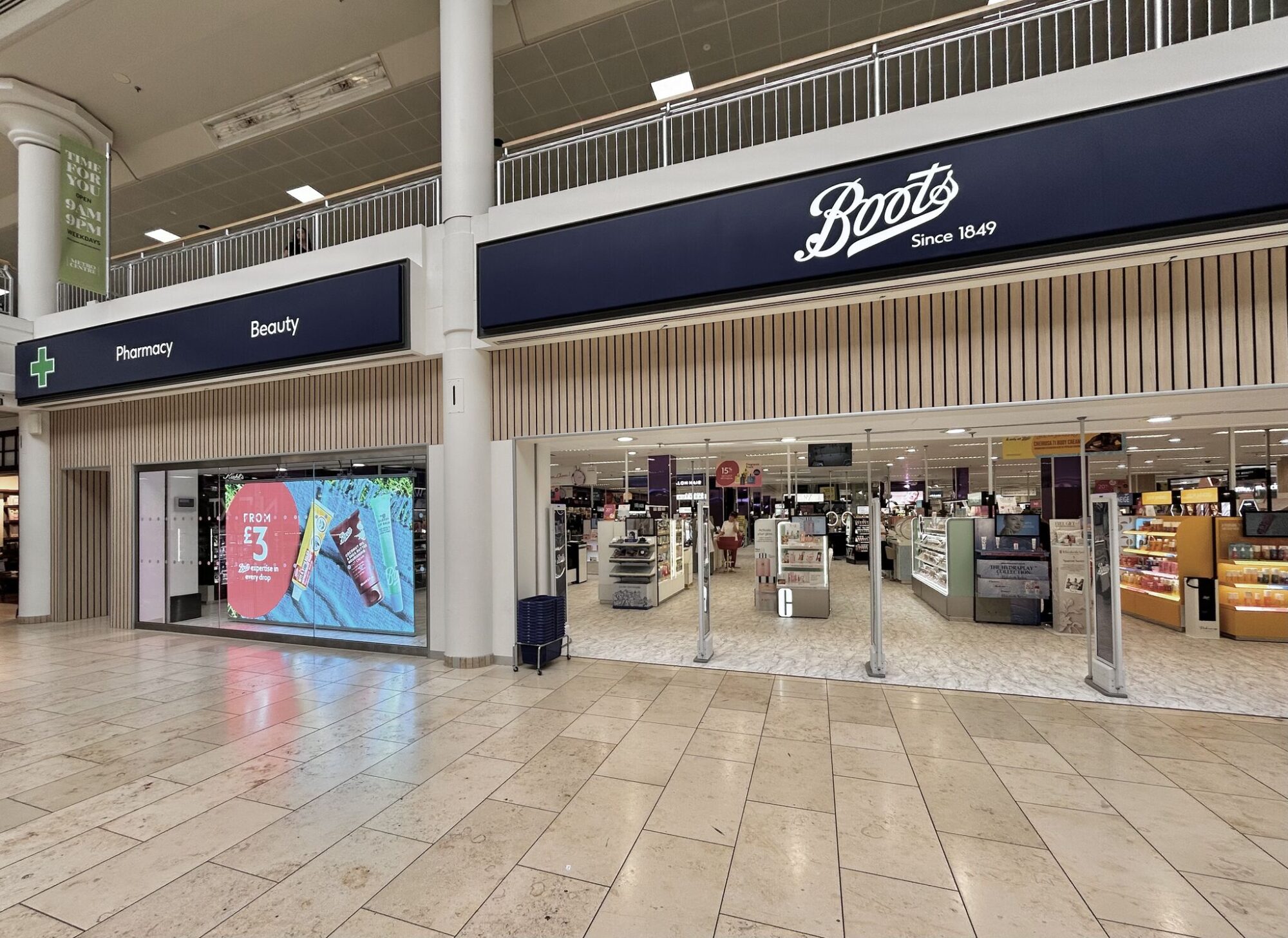 Entrance of a Boots store with pharmacy and beauty sections visible inside a shopping mall.