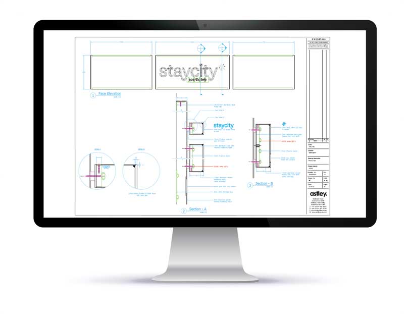 A computer monitor displays a technical drawing with detailed measurements and the word "staycity.