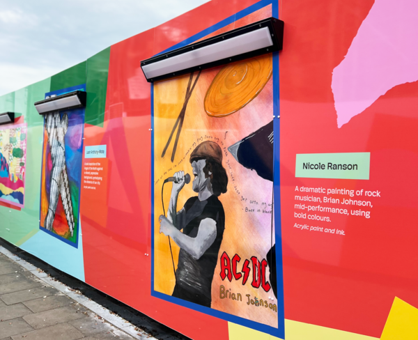 Colorful mural featuring a painting of a rock musician singing, with vibrant abstract backgrounds.