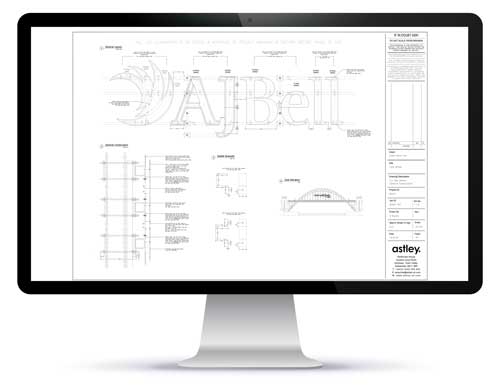 A computer monitor displays architectural plans with technical drawings and text, labeled "AJ Bell" and "astley.