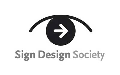 Black arrow inside a circle with an arch above, text reads "Sign Design Society.